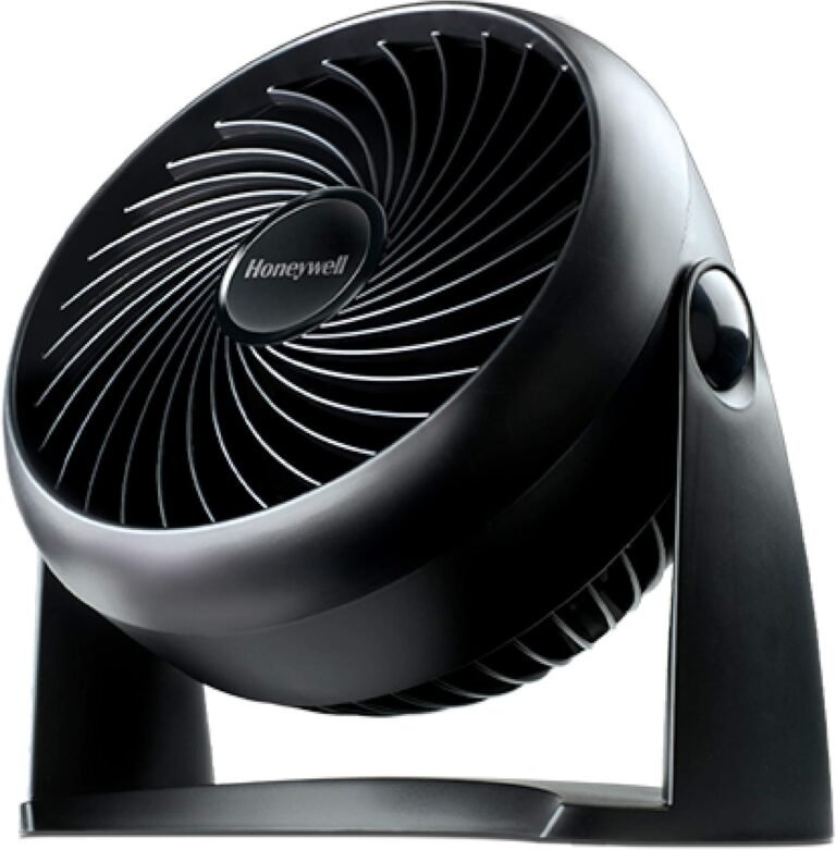 Close-up of a compact black Honeywell TurboForce Fan HT-900, angled slightly upwards, highlighting its unique spiral grille design and the 'Honeywell' logo in the center.