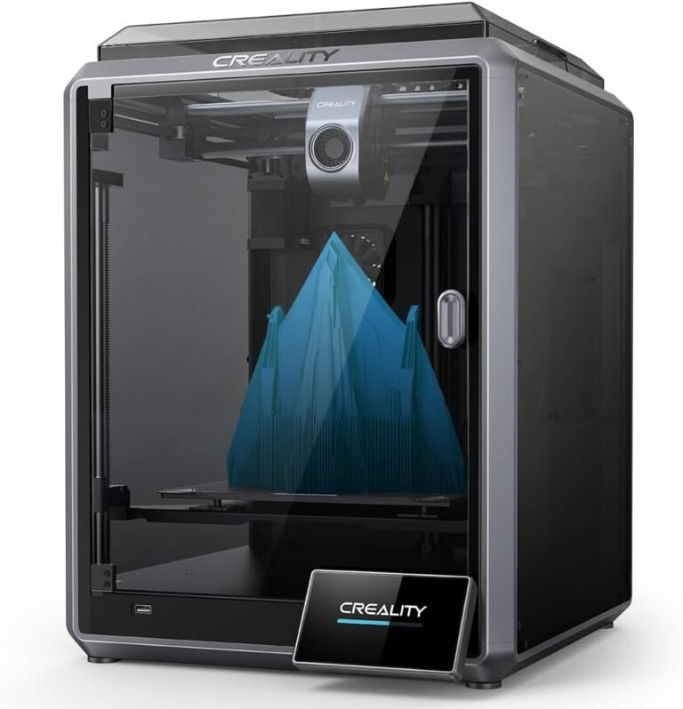 Creality 3D printer in a clear enclosure printing a blue geometric structure with multiple peaks on the build plate.