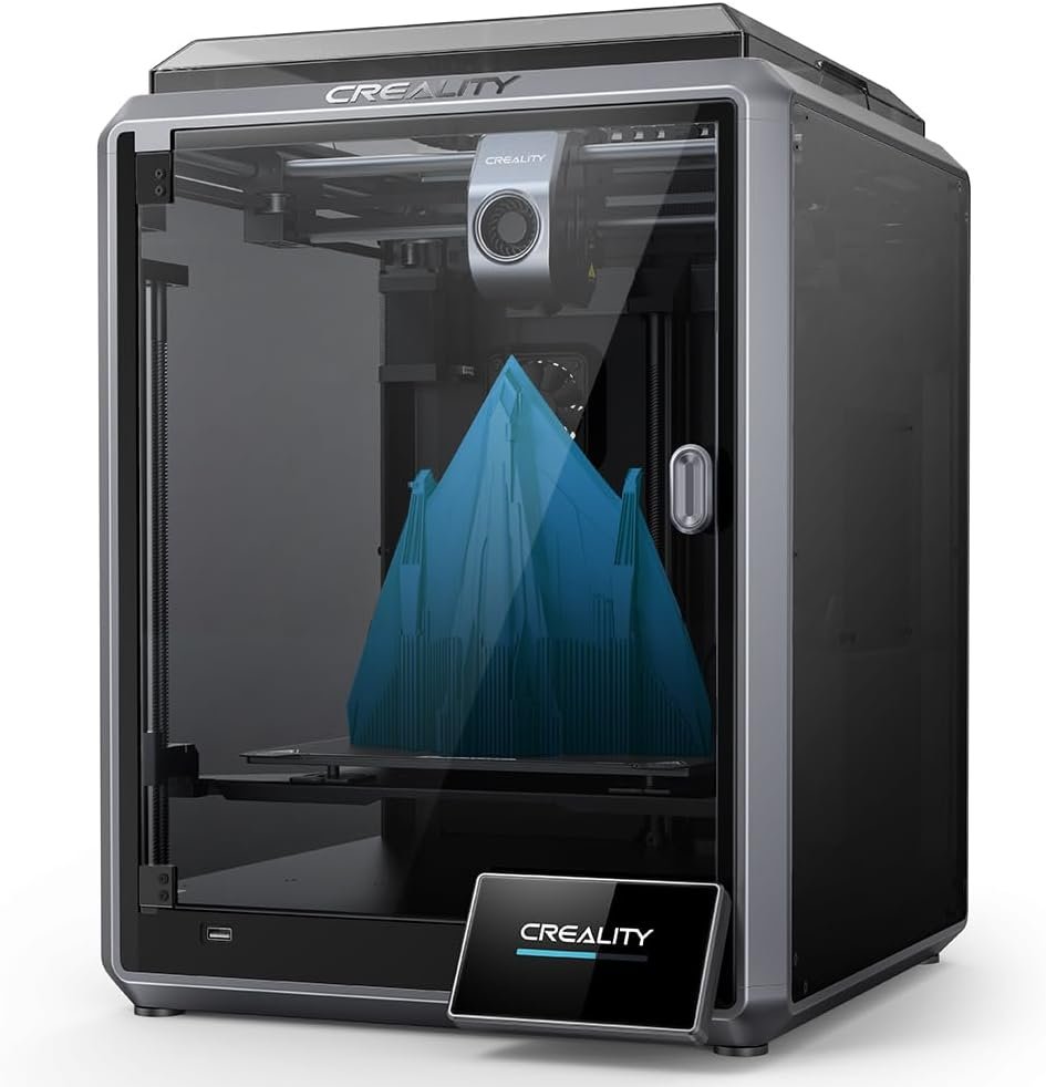 Creality 3D printer in a clear enclosure printing a blue geometric structure with multiple peaks on the build plate.