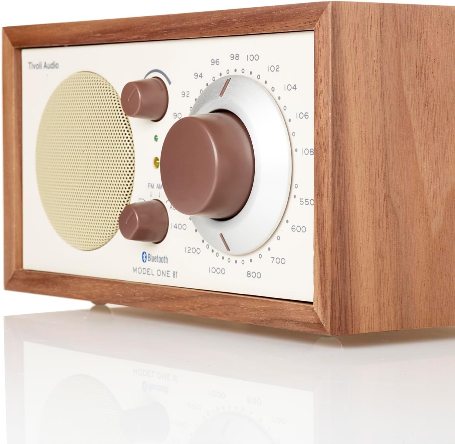 Retro-style Tivoli Audio Model One Bluetooth AM/FM radio in walnut wood finish, featuring a large tuning dial, volume and source knobs, and a front-facing speaker grille.