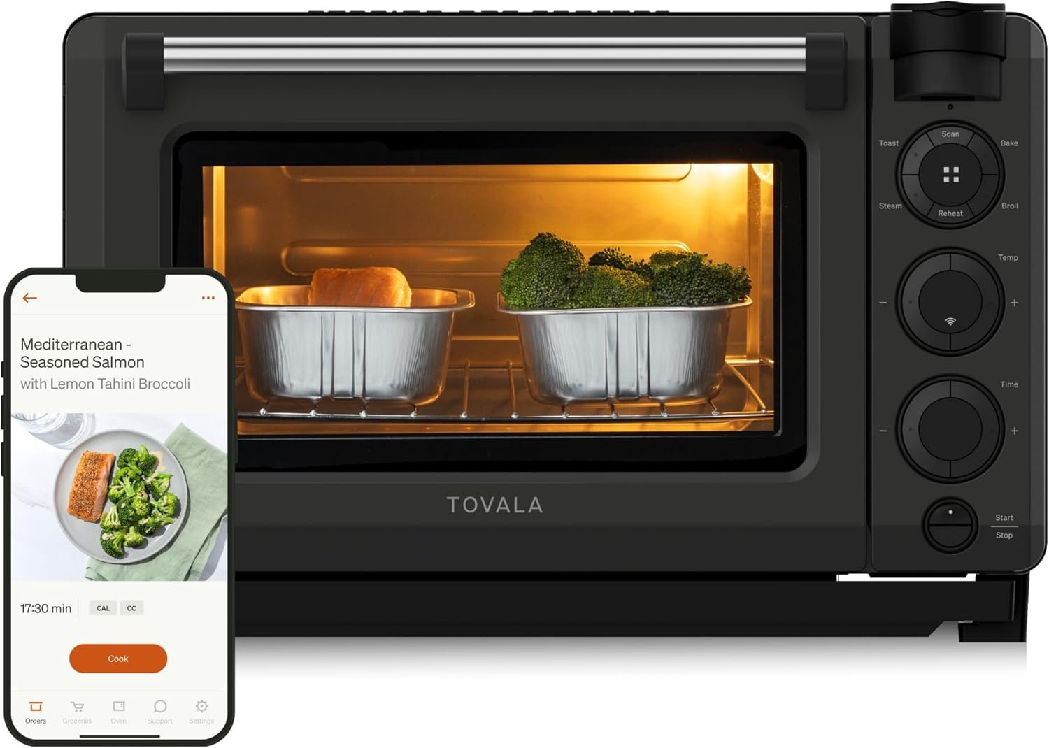 Tovala Oven Pro smart countertop oven with two trays inside, one containing salmon and the other broccoli, illuminated by the oven light. Next to it, a smartphone screen shows the Tovala app displaying a recipe for “Mediterranean Seasoned Salmon with Lemon Tahini Broccoli” and a cooking timer.