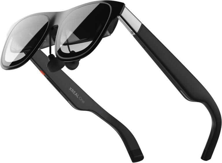 XREAL One AR Glasses in black, featuring a sleek sunglasses-style design with built-in speakers and slim side arms, shown at an angled view highlighting the frame and earpiece details.