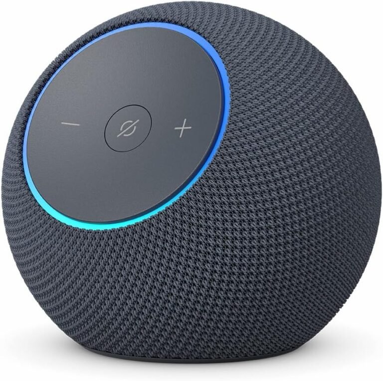 **Alt text:** A close-up image of the Amazon Echo Dot Max smart speaker in dark gray, showing its spherical mesh fabric design with touch controls for volume, microphone mute button, and a glowing blue light ring around the top edge.